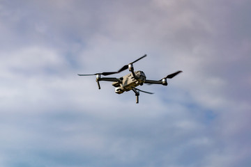 Drone with professional camera flying in the blue sky