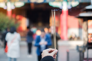 Wall Mural - Young woman traveler hand holding incense in Yuantong Temple, Buddhist temple in Kunming. landmark and popular for tourists attractions in Kunming, Yunnan, China. Asia travel concept