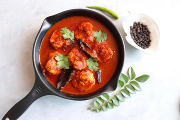 Goa Food-Indian Traditional Goan Prawns or Shrimp curry. Kolambiche kalwan/Tikhle. Hot and spicy homemade fish gravy cooked using coconut milk & Indian spices. ingredients background with copy space.