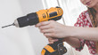 © Voyagerix - Hand holding yellow drill