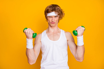 Sticker - Close-up portrait of his he nice attractive focused motivated guy doing work out with small light dumbbell self developing endurance isolated over bright vivid shine vibrant yellow color background