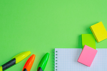 Back to school concept. School and office supplies on office table, green background. Flat lay with copy space.