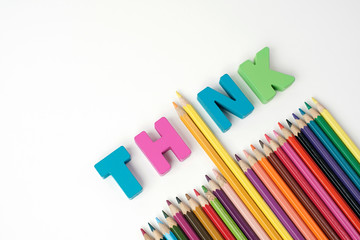 Wall Mural - ' THINK '  Wooden Letters, Color Pencil Instead ' I ' Letter with Multicolored Pencil on White Background                               