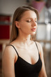 © Виталий Римдейка - Beautiful girl in a black top closeup who meditates at home