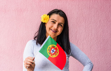 Sticker - Woman holds flag of Portugal in front of isolated wall background