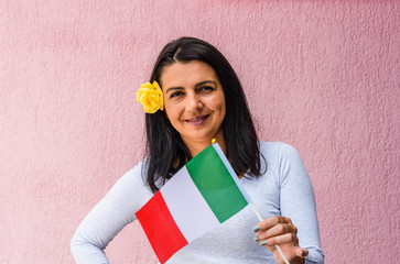 Sticker - Woman holds flag of Italy, in front of isolated wall background