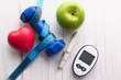 © Towfiqu Barbhuiya  - blood sugar measurement kits, dumbbell and apple on table