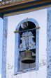 Close up of a church bell framed by a window, Diamantina, Minas Gerais, Brazil