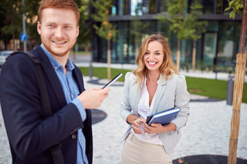 Wall Mural - Smiling business man and woman meeting outdoor.Young employees  outdoor.