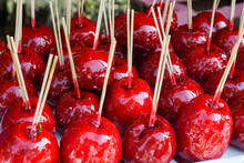 Sweet Glazed Red Toffee Candy Apples On Sticks For Sale On Farmer Market Or Country Fair.