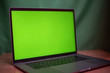 © toeytoey - Laptop with green screen on table in work space concept.