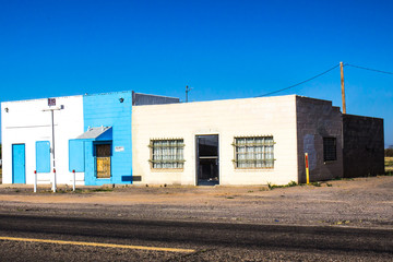 Two Abandoned Block Building With Bars On Windows