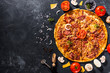 © Александр Захаров - Fragrant Italian pizza. Food ingredients and spices for cooking delicious Italian pizza, mushrooms, tomatoes, cheese, onions, peppers, salt, basil, olives on a dark concrete background