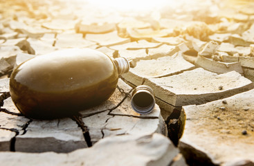 Wall Mural - Empty flask in the desert. Drought and water scarcity caused by global warming