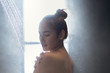 © torwaiphoto - Asian woman takes a shower and looks at her shoulder.