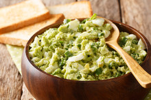 Traditional Avocado Salad With Eggs And Green Onions Close-up In A Bowl On The Table. Horizontal