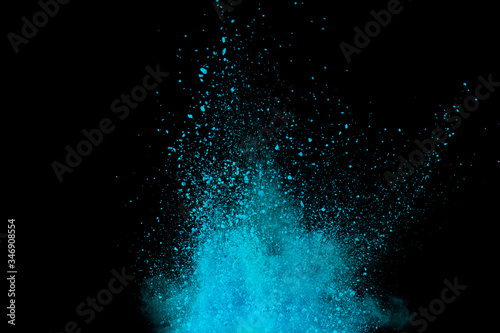 Fotografía Explosion of blue, aqua and violet dust on black background.