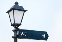 Public Toilet, Wc Or Restroom Sign On Vintage Street Light Pillar. Street Lamp With Wc Symbols