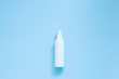 Top view of antibacterial antiseptic spray in white bottle for hands sanitizer on blue background. Cosmetic Or Hygiene white Spray Dispenser Pump Plastic Bottle. Protection against virus. Copy space. 