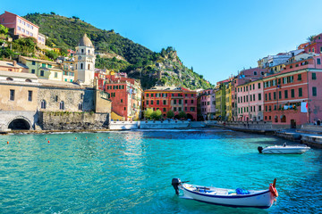 Wall Mural - Boat in the harbor of Vernassa. Ligurian coast of Italy. Cinque Terre National Park. Boat on the blue of the sea. Medieval city by the sea