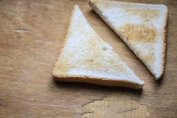 Two pieces of bread on a wooden table