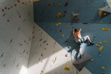 Shirtless Man Climbing On The Wall In Climbing Gym