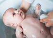 © Westend61 - Mother bathing her baby boy in a tub