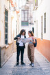 © Westend61 - Full length of couple reading map while standing on narrow street at Santa Cruz, Seville, Spain, Europe