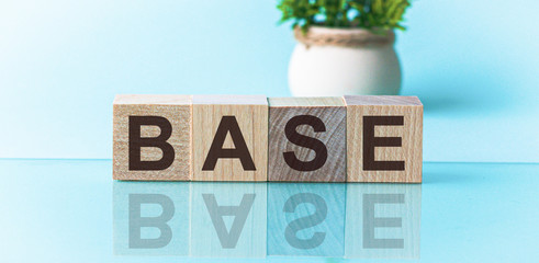 BASE - word from wooden blocks with letters, to divide or use something with others share concept, blue background