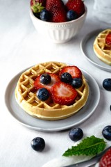 Wall Mural - Homemade mini Waffles topped with fresh berries and cream, selective focus