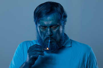 Wall Mural - portrait of a blue man with a blue beard with a cigarette