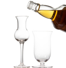 Two empty glasses in the shape of a tulip. A bottle of whiskey.