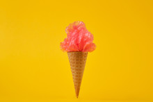 Plastic Bag In Ice Cream Cones On A Yellow Background