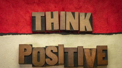 Sticker - Think positive - word abstract stop motion animation in vintage letterpress wood type blocks against colorful handmade papers, optimism and mindset concept