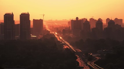 Wall Mural - top view on cityscape at sunrise urban city orange sunlight modern architecture