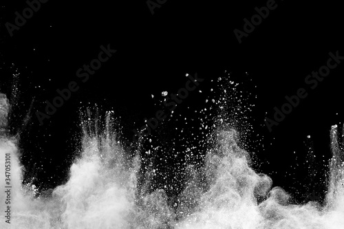 Fotomural Freeze motion of white dust particles splash on black background