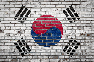 Wall Mural - Flag  banner on brick wall background.