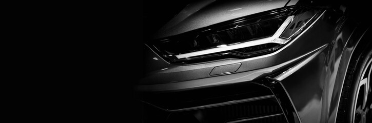 Detail on one of the LED headlights super car.copy space,black and white