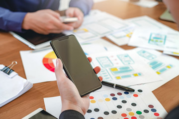 creative web designers and applications work together in the office.