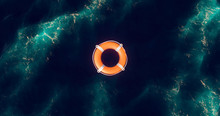 Lifebuoy Floating On Water. Life Preserver Floating In Ocean. Top View Of Rescue Ring. Life Belt In A Water After Shipwreck. Lifebuoy In Blue Sea.