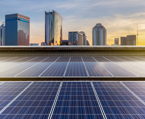 Solar Panel Photovoltaic installation on a Roof of factory, sunny blue sky background, alternative electricity source - Sustainable Resources Concept.