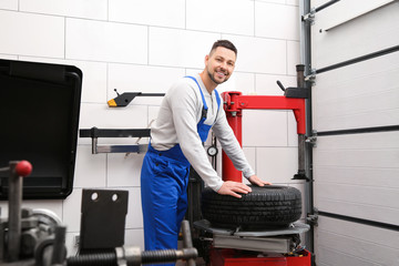 Wall Mural - Mechanic working with tire fitting machine at car service