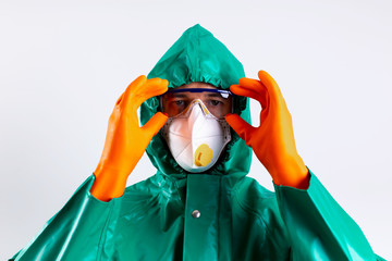 Man in protective suit putting on his goggles stock photo