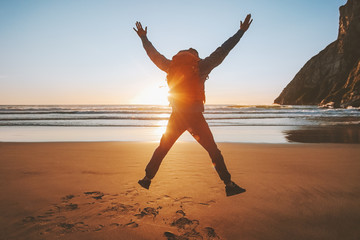 Wall Mural - Man jumping on beach travel healthy lifestyle active vacations outdoor adventure success happy emotions traveler enjoying sunset ocean landscape