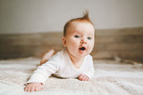 Cute baby infant crawling at home curious child portrait family lifestyle 3 month old girl kid