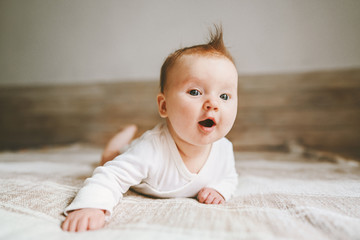 cute baby infant crawling at home curious child portrait family lifestyle 3 month old girl kid