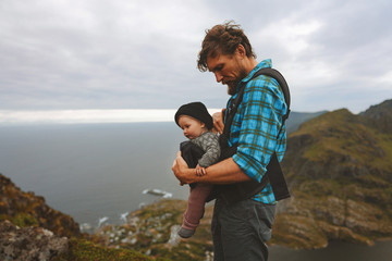 Family travel father walking with baby carrier outdoor man hiking with infant child  summer trip vacations active  healthy lifestyle Father’s Day holiday