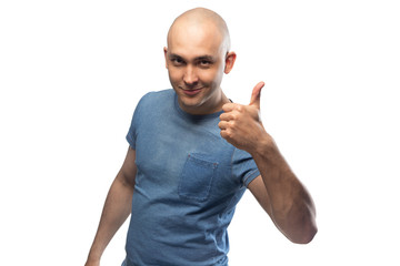 Wall Mural - Young bald man in blue t-shirt showing thumb