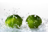 Fototapeta Łazienka - lime with splashes and streams of water on a black or white background isolated