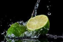 Lime With Splashes And Streams Of Water On A Black Or White Background Isolated